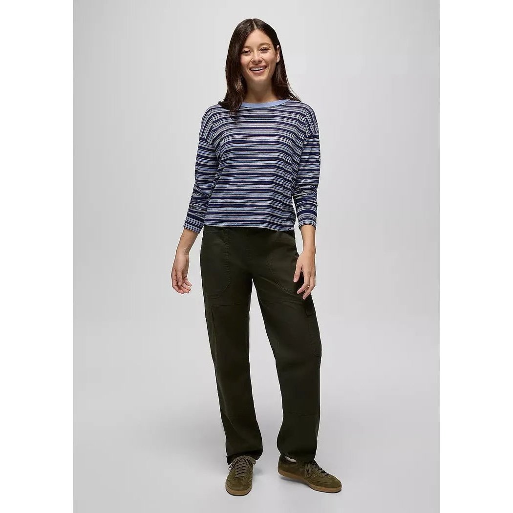 A woman wearing the Prana Women's Cozy Up Long Sleeve Crew in Capulet Blue Stripe stands against a plain background.