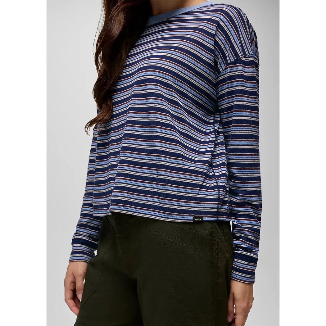 A woman wearing the Prana Women's Cozy Up Long Sleeve Crew in Capulet Blue Stripe is shown from the side against a plain background.