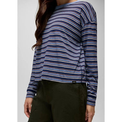 A woman wearing the Prana Women's Cozy Up Long Sleeve Crew in Capulet Blue Stripe is shown from the side against a plain background.