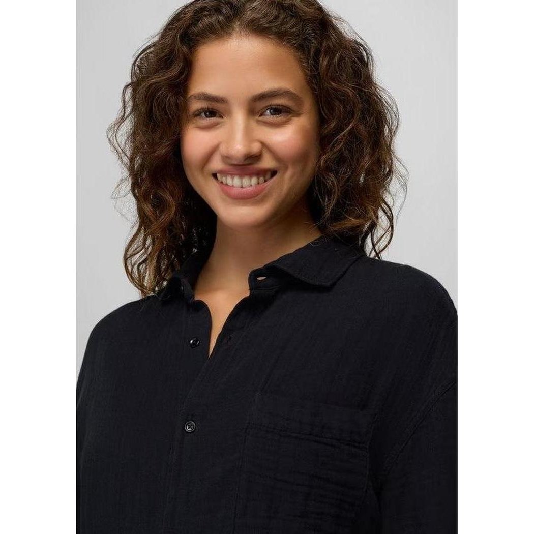 A front view of the Prana Women's Hideaways Button Down Top in Black on a model with curly hair against a light gray background.