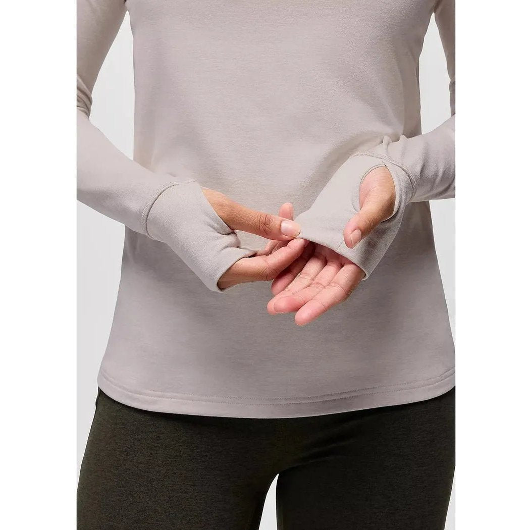 A front view of the Prana Women's Ice Flow Long Sleeve in Almond Heather showing the cuffs and a model wearing it against a plain background.