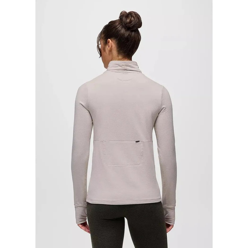 Back view of the Prana Women's Ice Flow Long Sleeve in Almond Heather showing the back pocket and a model wearing it against a plain background.