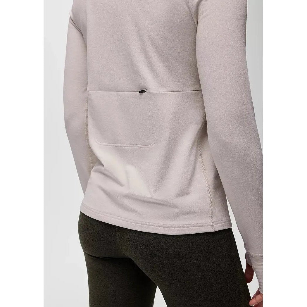 Back view of the Prana Women's Ice Flow Long Sleeve in Almond Heather showing the back pocket and model wearing it against a plain background.