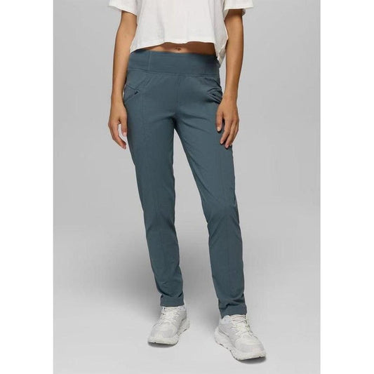A front view of the Prana Women's Koen Mid Rise Daily Pant in Grey Blue on a model wearing white sneakers against a plain background.
