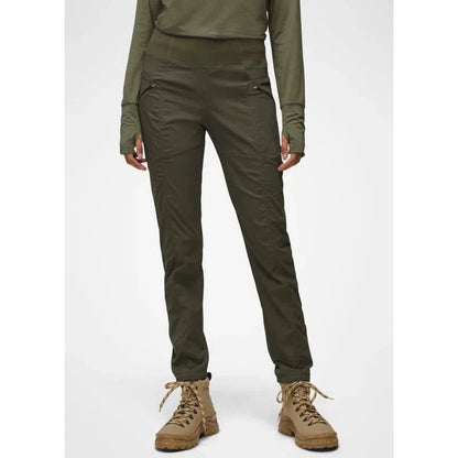 A front view of the Prana Women's Koen Pant in Black on a model wearing tan hiking boots against a plain white background.