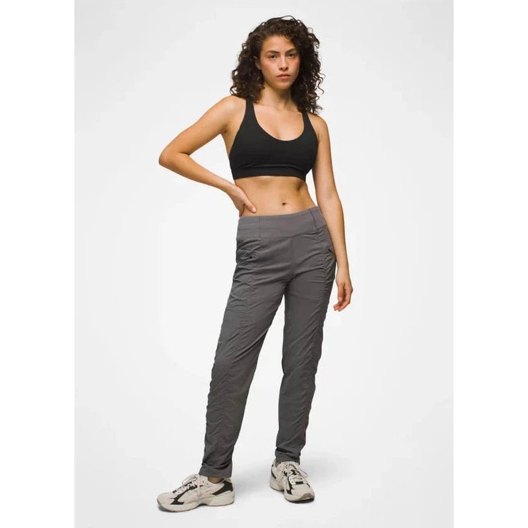 A model wearing the Prana Women's Koen Pant in Black stands against a plain white background.