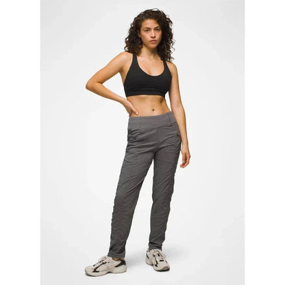 A model wearing the Prana Women's Koen Pant in Black stands against a plain white background.