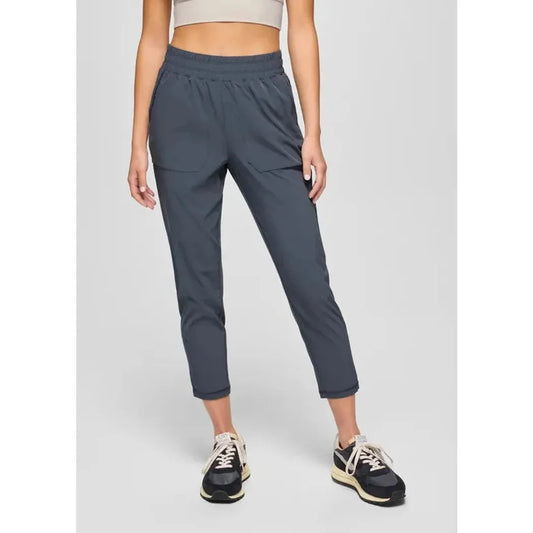 A front view of the Prana Women's Railay Straight Pant in Stormy Night, showing the cropped fit and elastic waistband on a model wearing athletic shoes against a plain background.