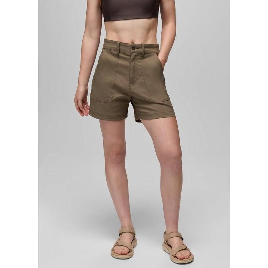 A front view of the Prana Women's Stretch Zion Cargo Short in Mud, showing the model wearing them with a plain gray background.