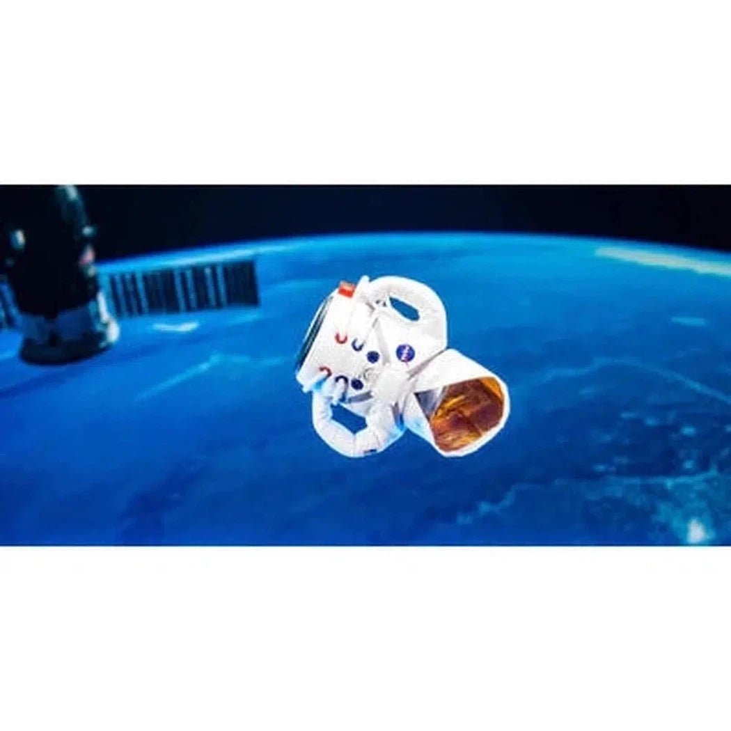 A small Puffin Coolers The Space Suit in Sandy White floats in front of a blue Earth background.