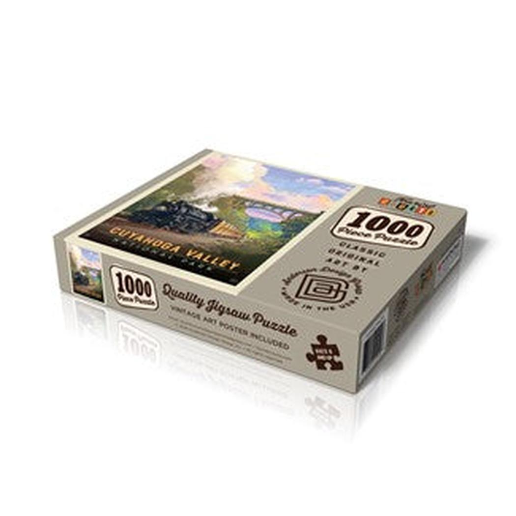 A top-down view of the Pumpernickel Press Cuyahoga Valley Np - Historic Railway 1000-piece puzzle box with a train image on the front.