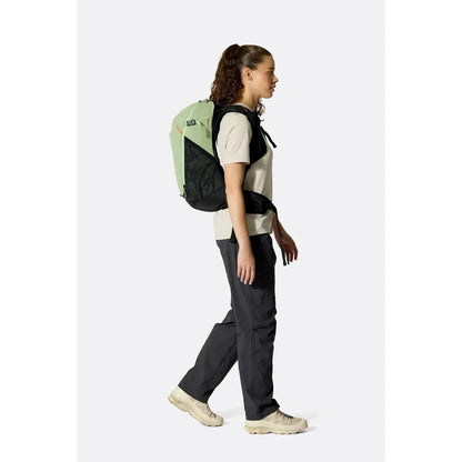 Side view of the Rab Airox 22ND in Fig Green/Black on a model walking against a white background.