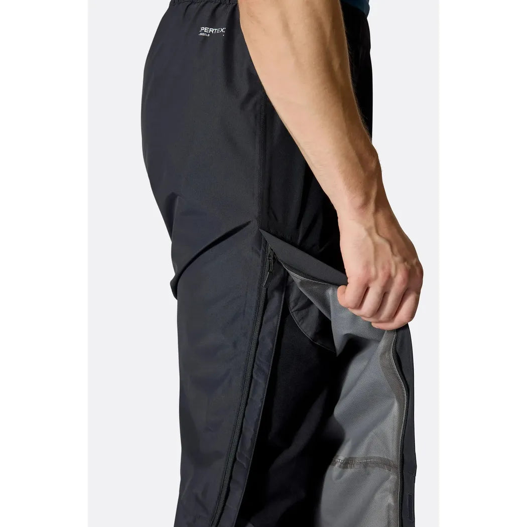 Side view of the Rab Men's Downpour Pants in Black showing the inner lining and zipper pocket against a white background.