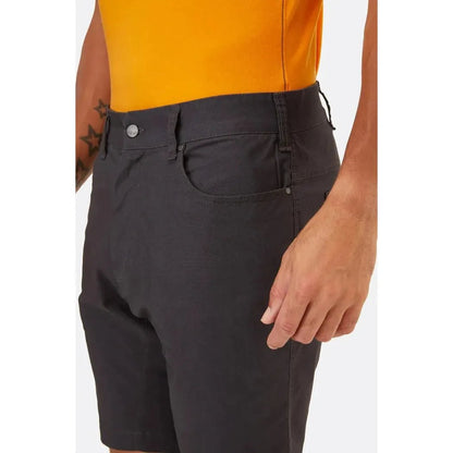 Side view of the Rab Men's Radius Shorts in Anthracite showing the front pocket and model wearing them against a white background.