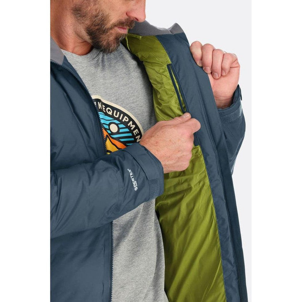 A man wearing the Rab Men's Valiance Jacket in Black shows the green interior lining from a side angle against a white background.