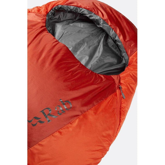 A close-up of the Rab Solar Eco 1 sleeping bag in Red Clay showing the zipper and interior lining against a white background.