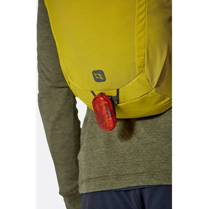 Back view of the Rab Tygen 12 backpack in Black showing the rear light attachment on a model wearing it.
