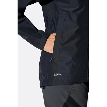 Side view of the Rab Women's Downpour Jacket in Black showing the Pertex logo and a model's hand in the pocket against a white background.