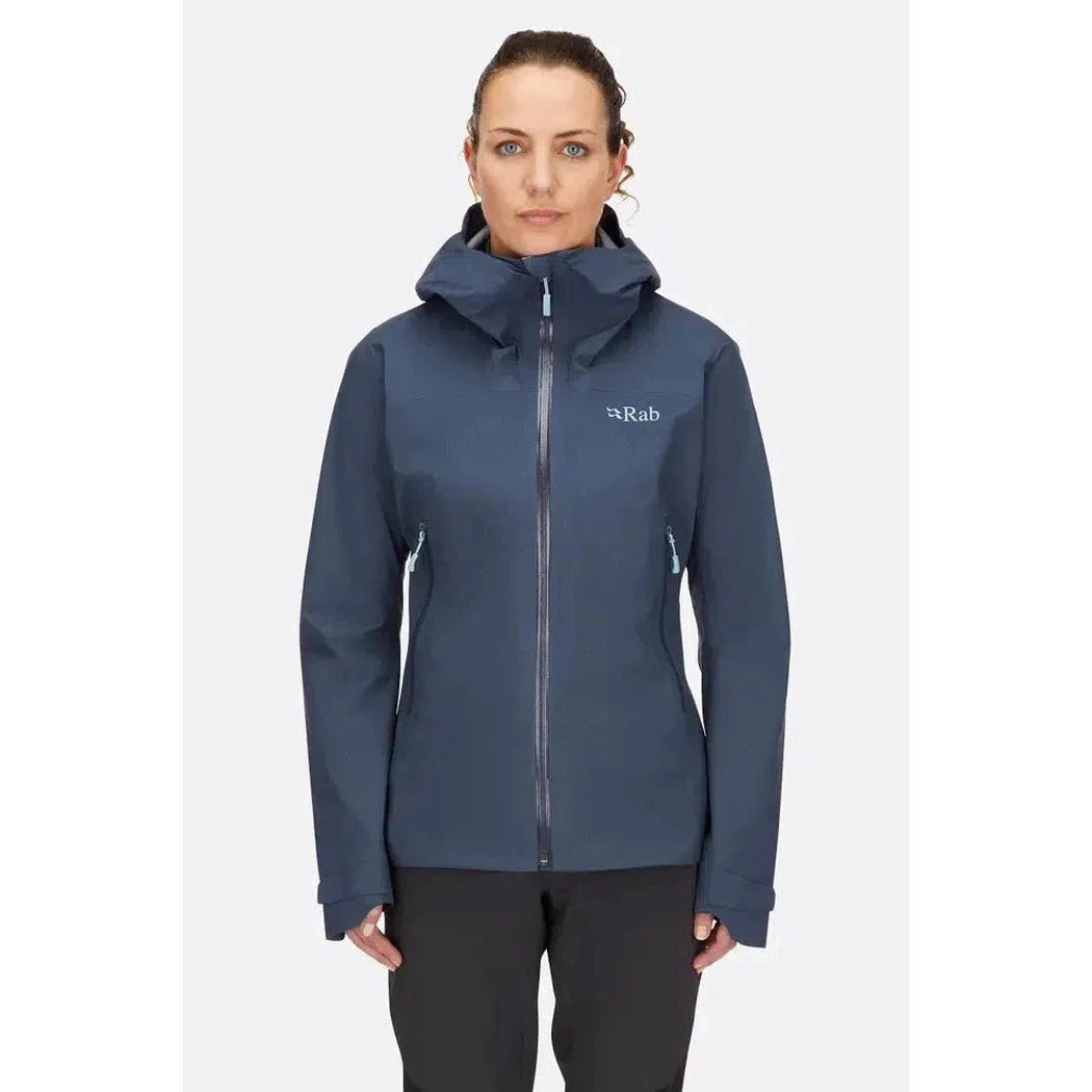 A front view of the Rab Women's Downpour Light Jacket in Tempest Blue on a model against a plain white background.