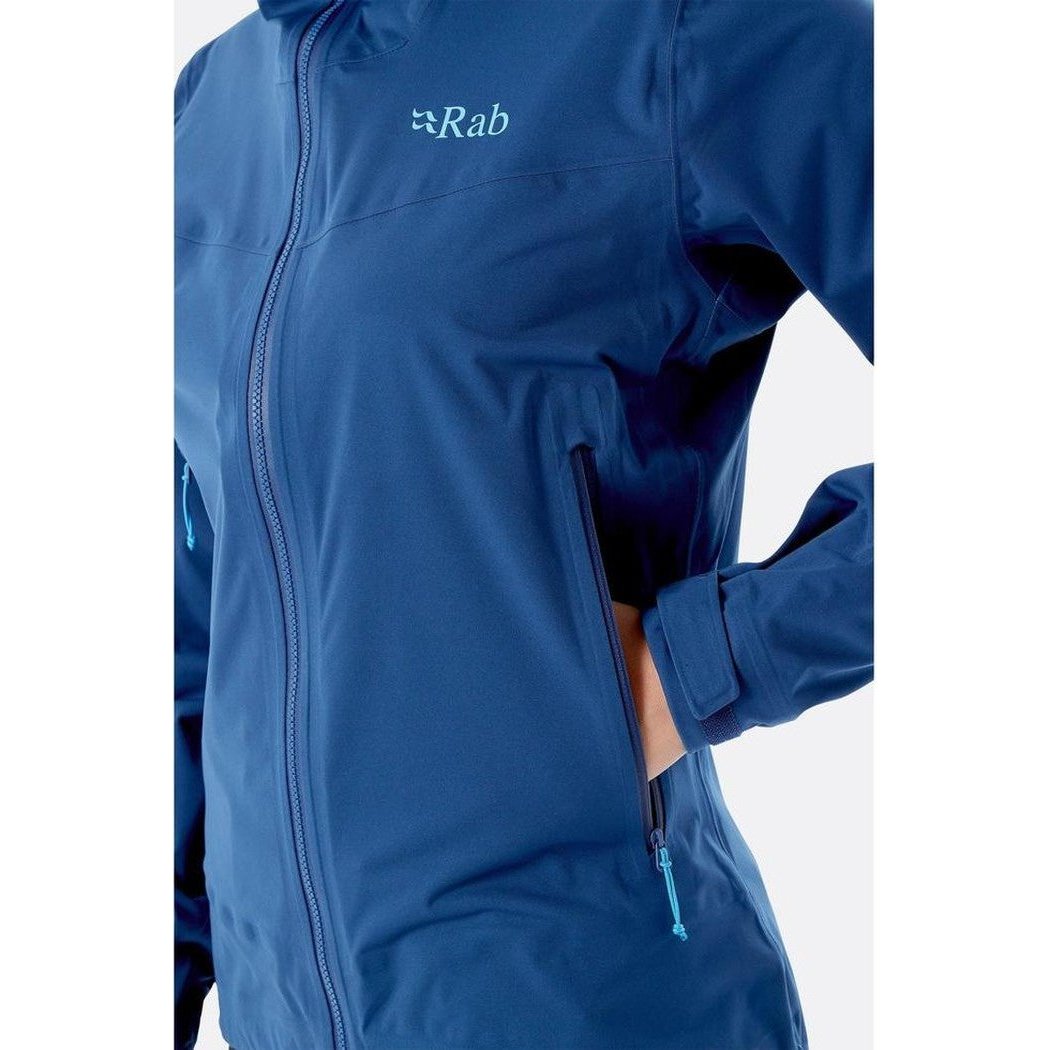 A close-up of the Rab Women's Kinetic 2.0 Jacket in Ultramarine, showing the front zipper and a hand in the pocket against a white background.
