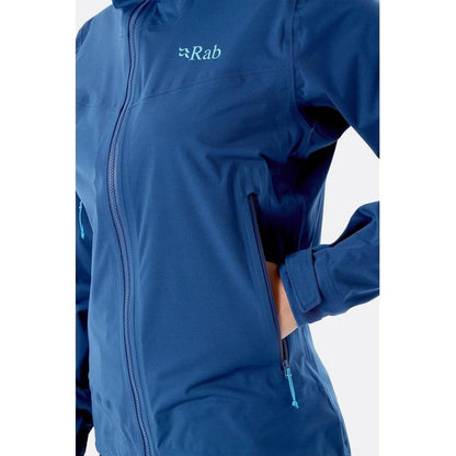A close-up of the Rab Women's Kinetic 2.0 Jacket in Ultramarine, showing the front zipper and a hand in the pocket against a white background.