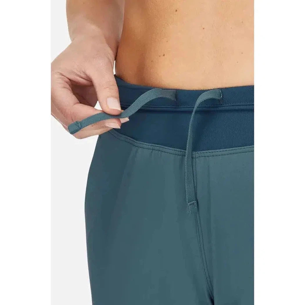 A close-up of a woman wearing the Rab Women's Momentum Pants in Beluga, showing the waistband and drawstring against a plain background.