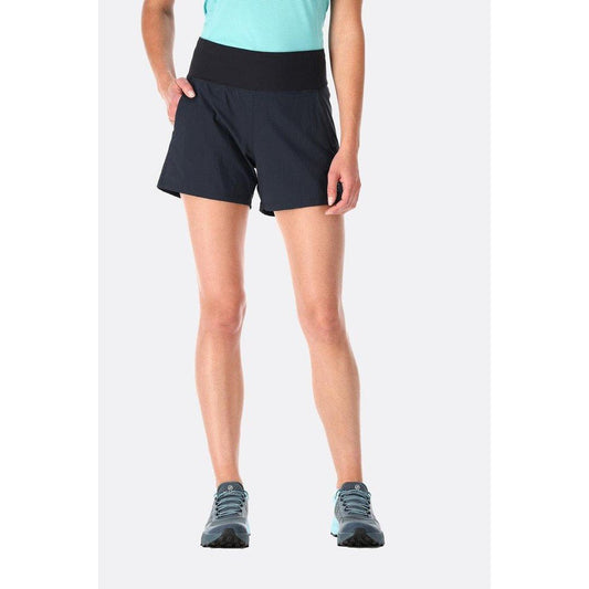 A front view of the Rab Women's Momentum Shorts in Beluga color, showing the high waistband and pockets, with a model wearing them against a plain white background.