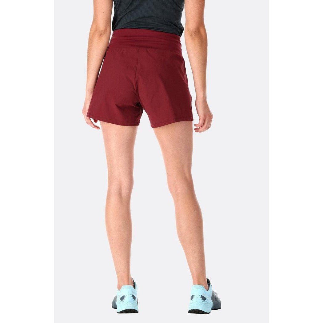 Back view of the Rab Women's Momentum Shorts in Beluga, showing the high waist and model wearing light blue sneakers against a plain background.