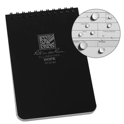 A top view of the black Rite in the Rain Dope Logbook with a spiral binding and a close-up of its weather-resistant surface.