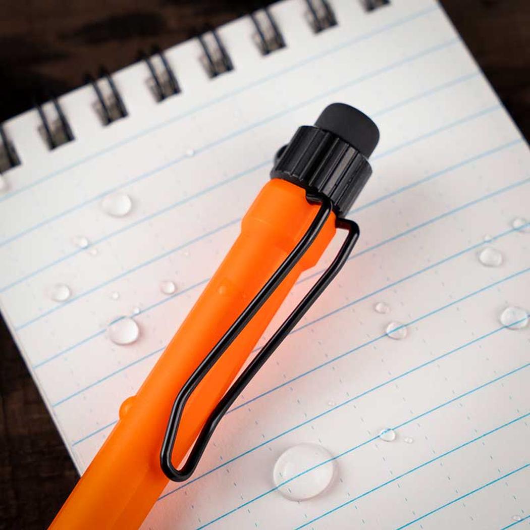A close-up of the Rite in the Rain Precision TWIST Pencil - 0.9MM in Orange on a lined notebook with water droplets.