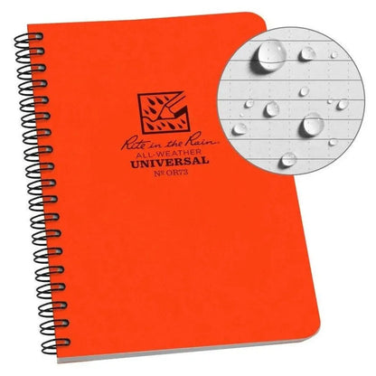 A black Rite in the Rain Side Spiral Notebook 4 5/8 x 7 is shown from the side with a close-up of water droplets on the paper.