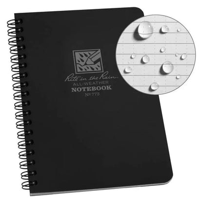 A black Rite in the Rain all - weather notebook with a close - up of water droplets on the paper.