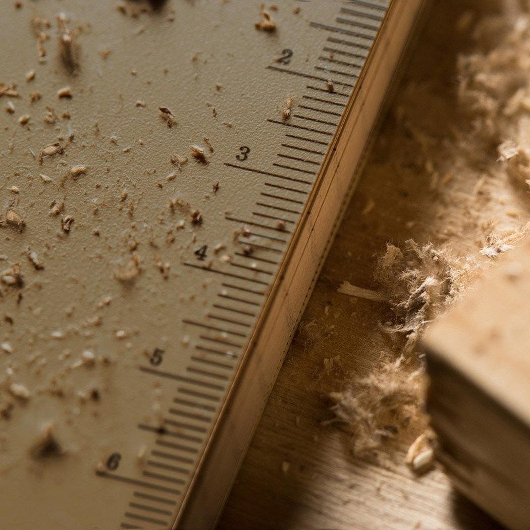 A close-up of the Rite in the Rain Side Spiral Notebook 4 5/8 x 7 in Black, showing the ruler and wood shavings on the surface.