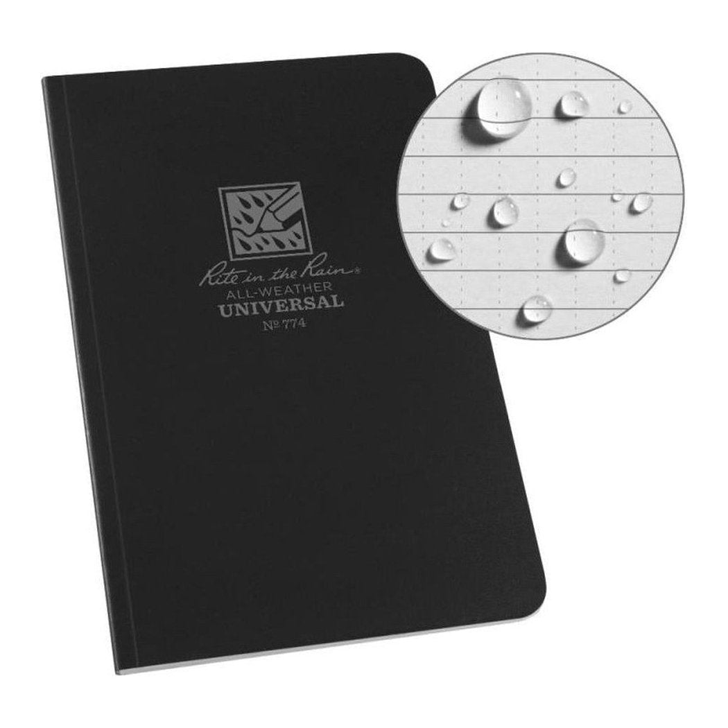 A black Rite in the Rain Soft Cover Book with a close-up of water droplets on the paper.