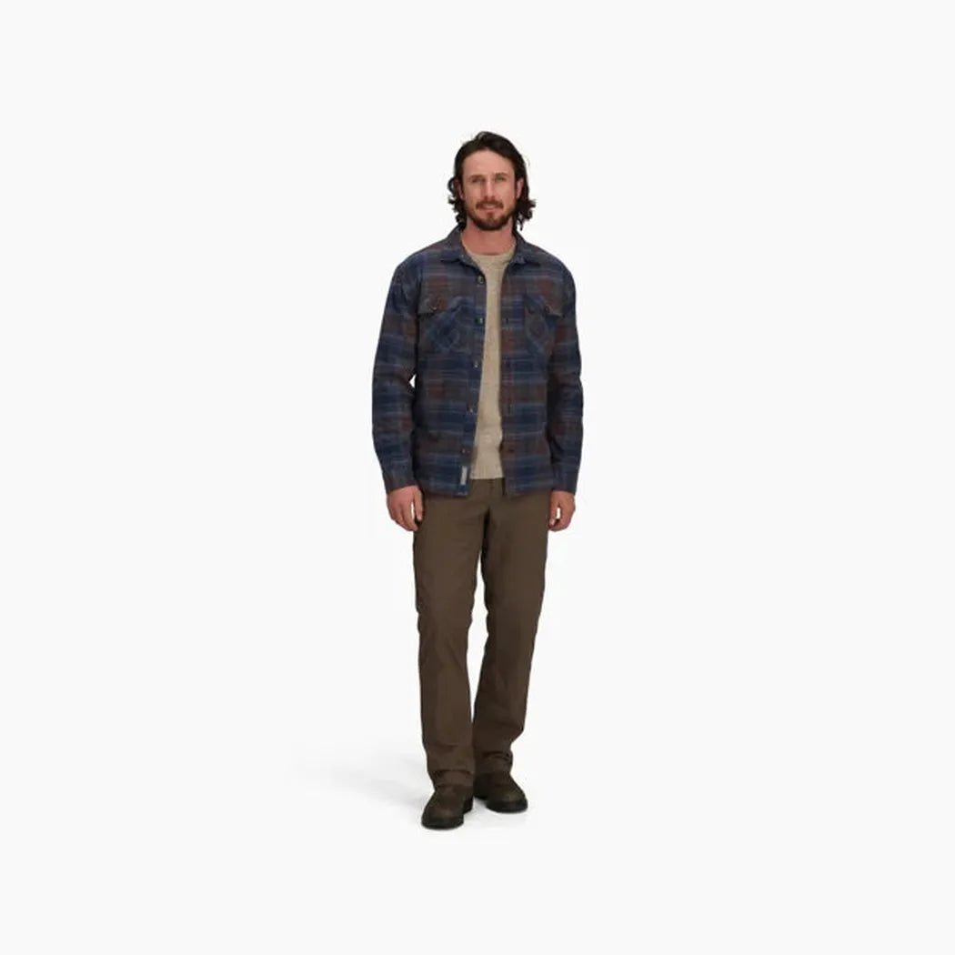 A model wearing the Royal Robbins Men's Snowcap Lined Flannel in Navy Tioga Pld stands against a plain white background.