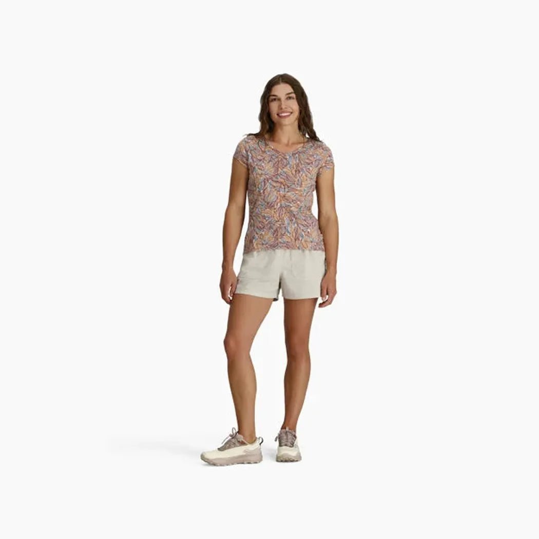 A woman wearing the Royal Robbins Women's Featherweight Slub Tee in Chalk Marigold Pt stands against a white background.