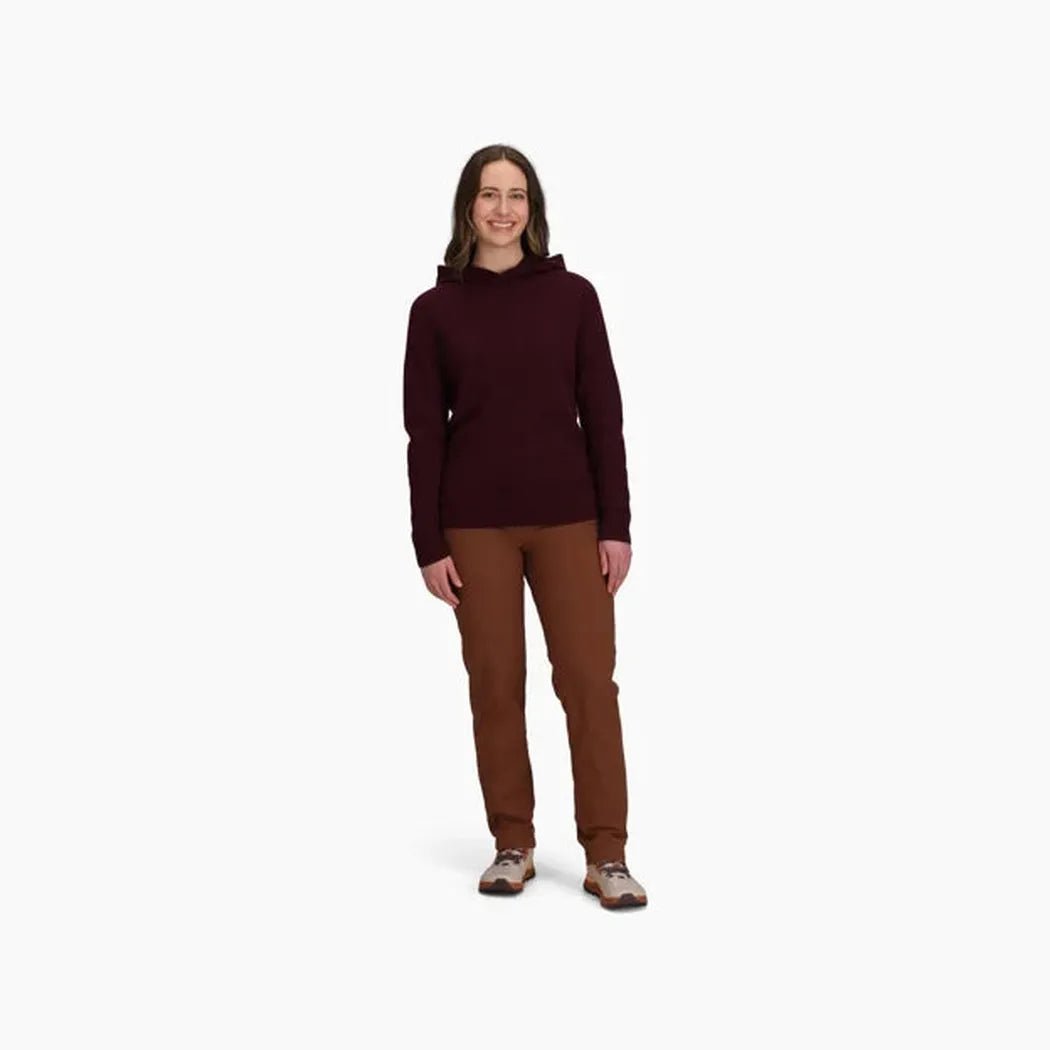 A woman wearing the Royal Robbins Women's Rockcraft Wool Hoodie in Loganberry Htr stands against a white background.