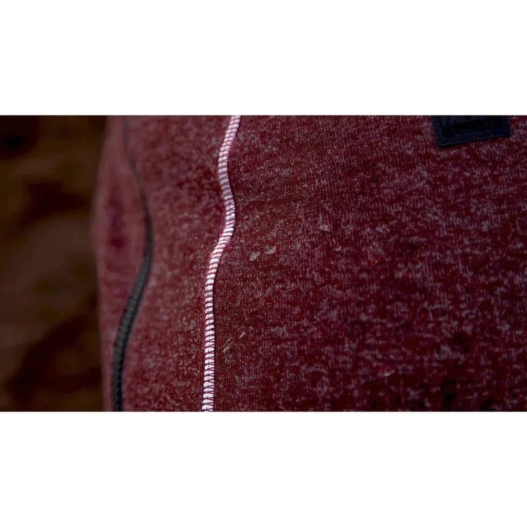Close-up of the Ruffwear Hemp Hound Sweater in Fired Brick showing the white zipper and dark tag on the fabric.