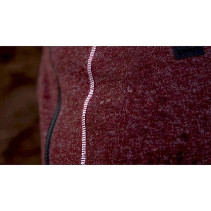 Close-up of the Ruffwear Hemp Hound Sweater in Fired Brick showing the white zipper and dark tag on the fabric.