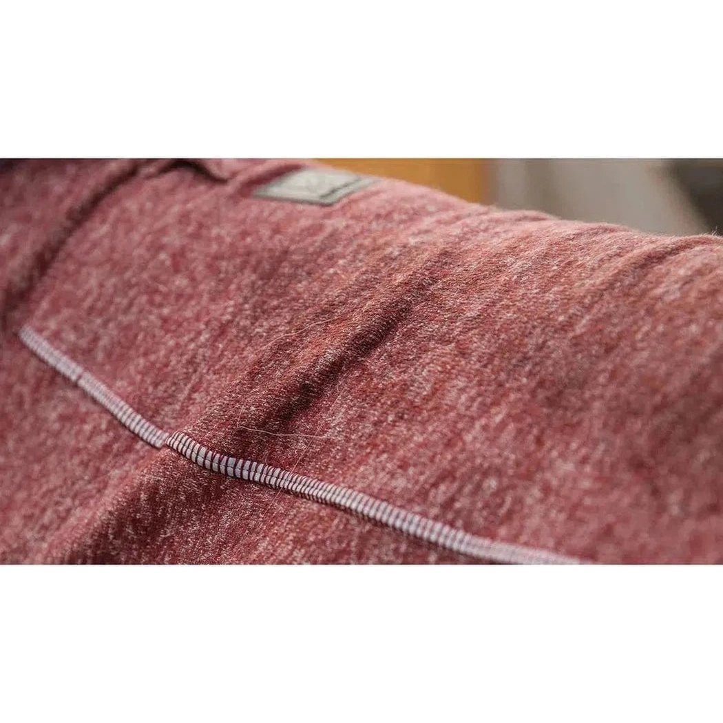 Close-up of the Ruffwear Hemp Hound Sweater in Fired Brick showing the stitching and a tag on the shoulder.