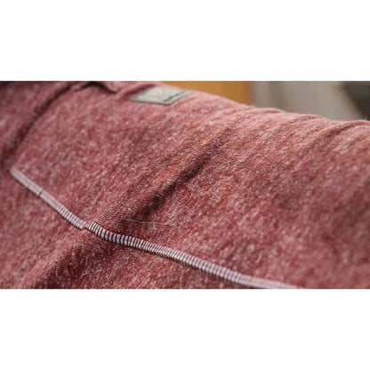 Close-up of the Ruffwear Hemp Hound Sweater in Fired Brick showing the stitching and a tag on the shoulder.