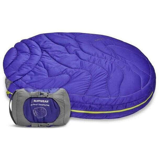A full view of the Ruffwear Highlands Dog Sleeping Bag in Huckleberry Blue with its gray compression sack visible in front.