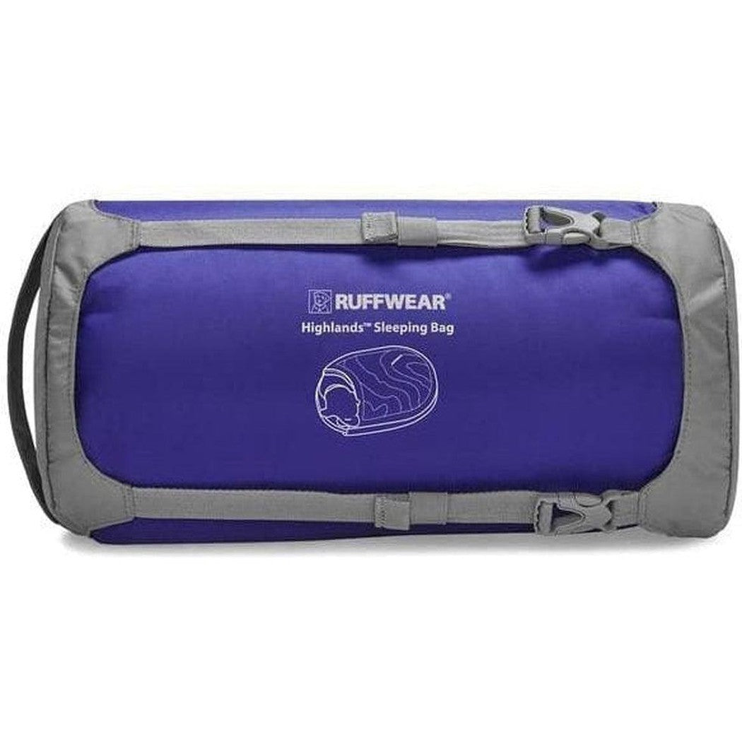 A front view of the Ruffwear Highlands Dog Sleeping Bag in Huckleberry Blue with gray trim and a logo on the front.