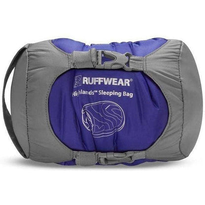 A front view of the Ruffwear Highlands Sleeping Bag in Huckleberry Blue showing the buckle closure and logo on a white background.