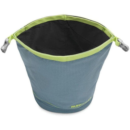 A top-down view of the Ruffwear Kibble Kaddie in Slate Blue with a black interior and lime green trim, showing the brand name on the bottom.