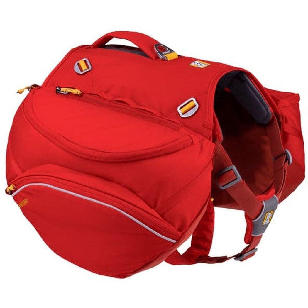 A red Ruffwear Palisades Pack with multiple pockets and straps, photographed from a side angle against a white background.