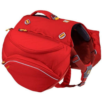 A red Ruffwear Palisades Pack with multiple pockets and straps, photographed from a side angle against a white background.