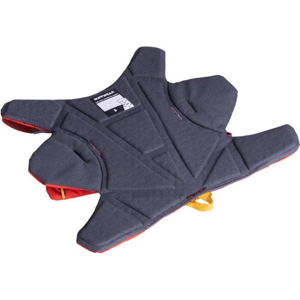 A top-down view of the Ruffwear Palisades Pack in Red Sumac showing the padded design and yellow buckle against a white background.