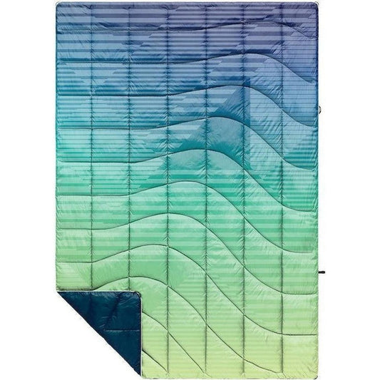 A top-down view of the Rumpl Nanoloft Puffy Patch Fade Warm blanket showing its quilted design and gradient color pattern.