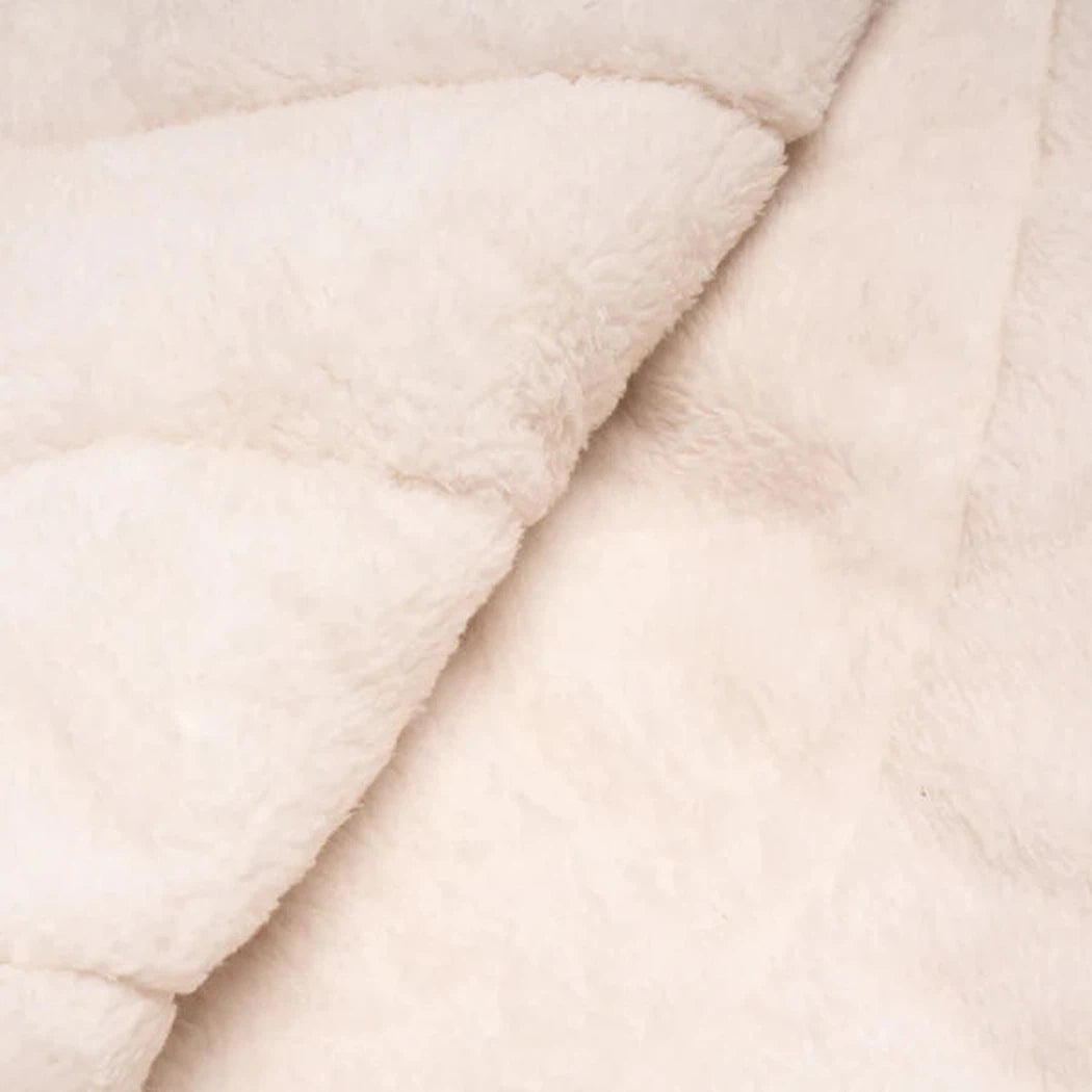 A close-up of the Rumpl Sherpa Puffy blanket in Deepwater color, showing its soft texture and folded layers.
